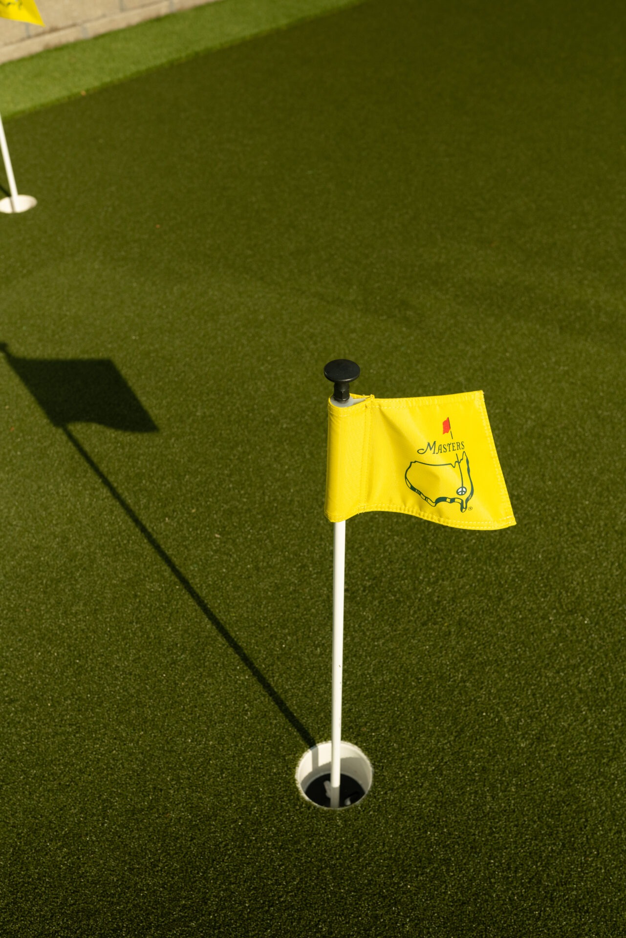 A golf putting green with a yellow 