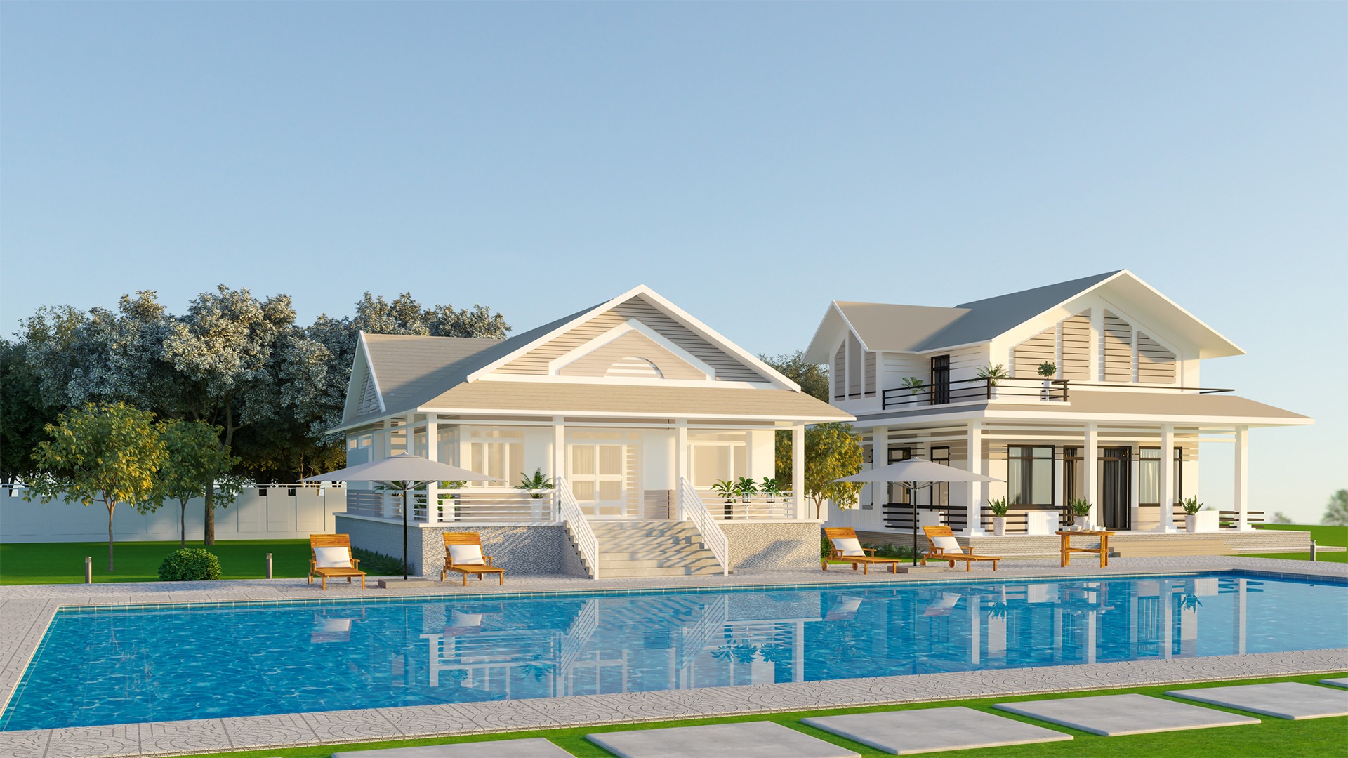 Two modern, white houses with large windows stand beside a clear blue swimming pool, surrounded by trees and greenery under a clear sky.